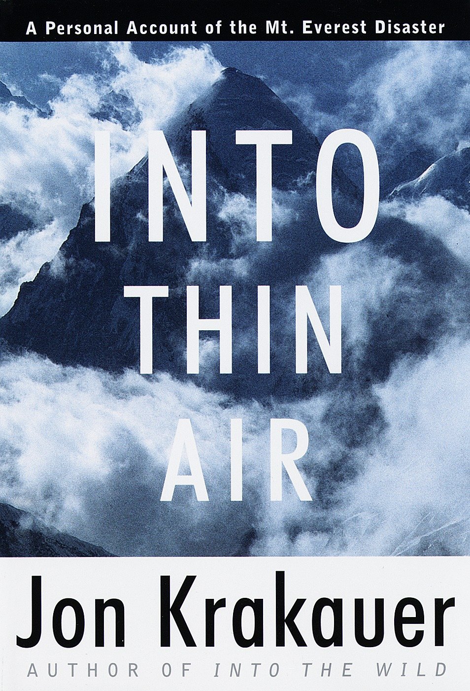 Into Thin Air Book Cover Shows Mount Everest Surrounded by clouds. This classic mountaineering book is authored by Jon Krakauer